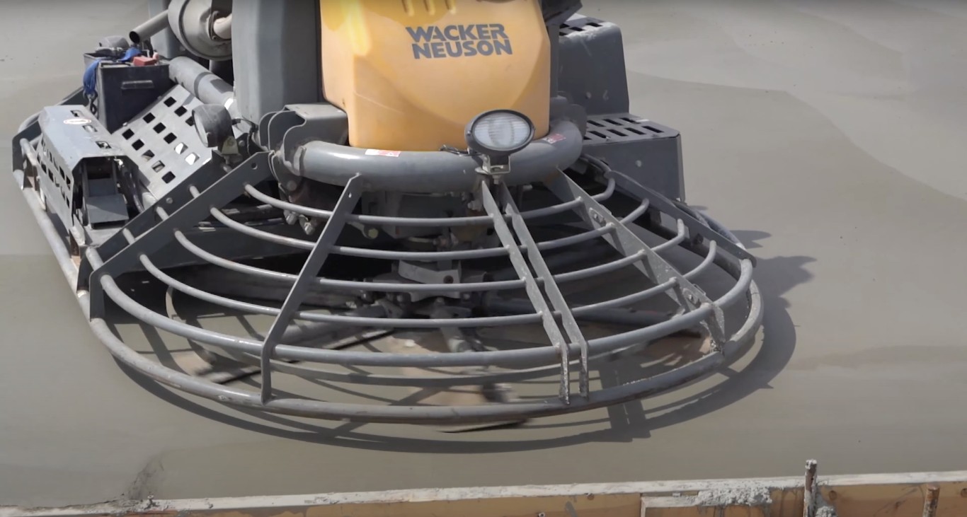Power trowel machine finishing fresh concrete slab surface